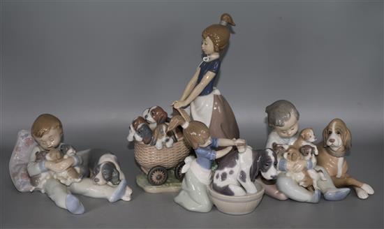 A group of four Lladro figures of childrens and puppies
